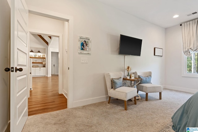 living area with vaulted ceiling with beams and carpet floors