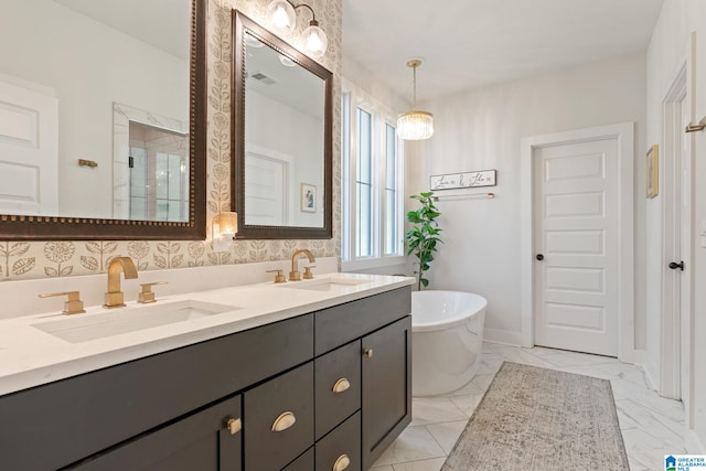 bathroom with vanity and shower with separate bathtub