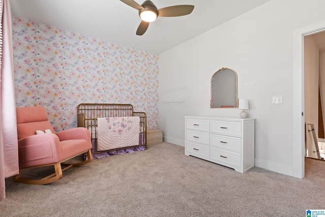 carpeted bedroom with a nursery area and ceiling fan