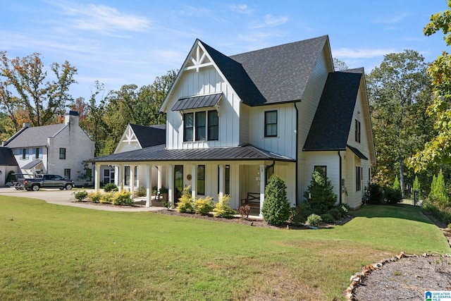 modern farmhouse featuring covered porch and a front lawn