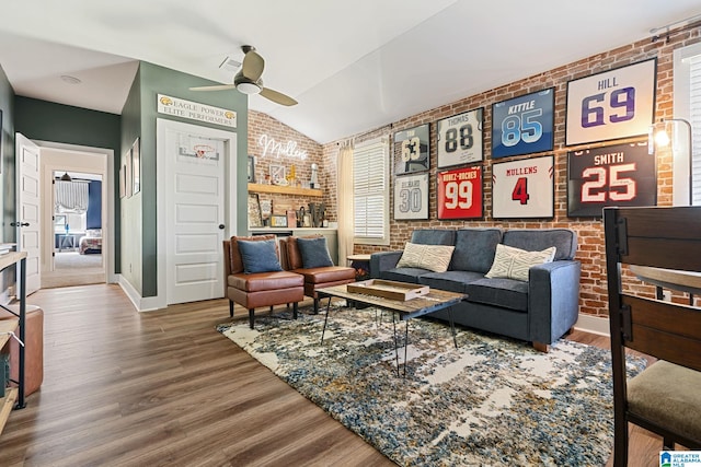 living room with ceiling fan, wood-type flooring, lofted ceiling, and brick wall