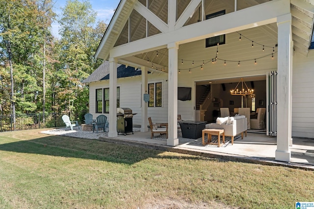 back of property with a patio area, a yard, and an outdoor living space with a fire pit