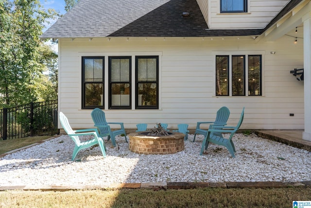 rear view of house featuring a patio area and an outdoor fire pit