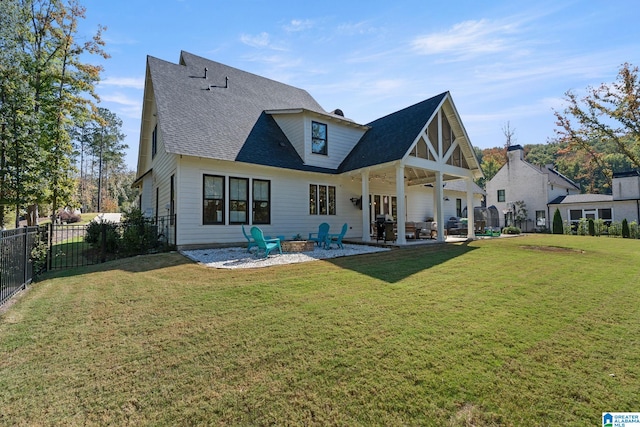 back of house with a lawn and a patio