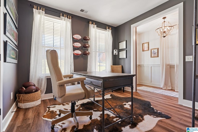 office space featuring a wealth of natural light, a chandelier, and wood-type flooring