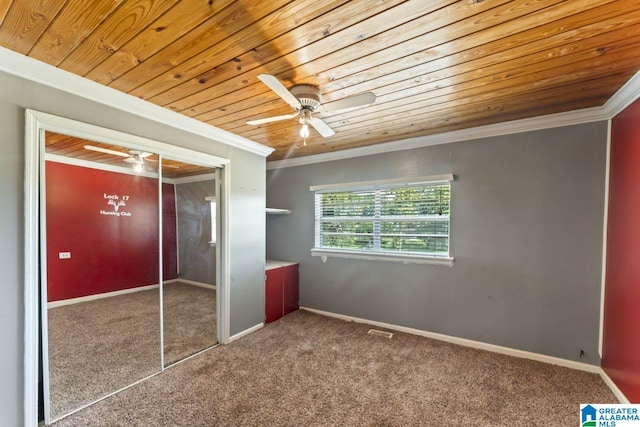 unfurnished bedroom featuring ceiling fan, a closet, carpet, and ornamental molding