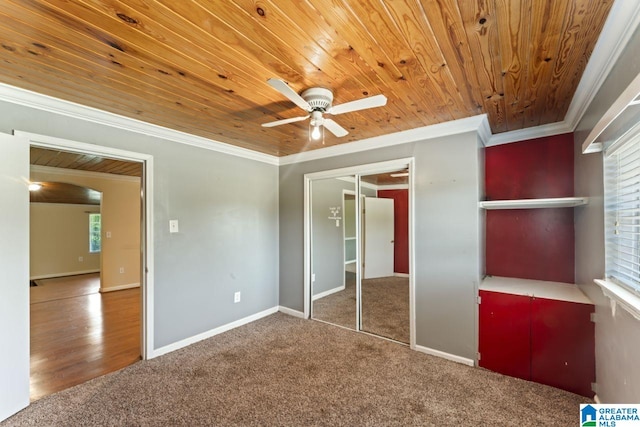 unfurnished bedroom featuring ceiling fan, a closet, carpet floors, and ornamental molding