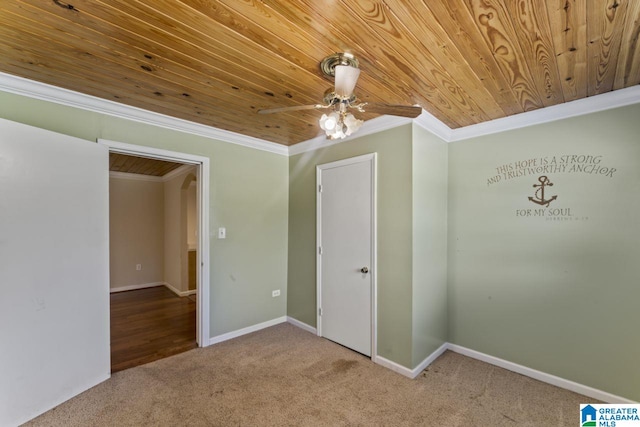 carpeted spare room featuring ceiling fan, crown molding, and wood ceiling