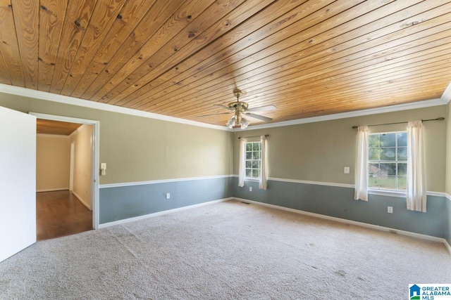 empty room with carpet, ornamental molding, wood ceiling, and a wealth of natural light