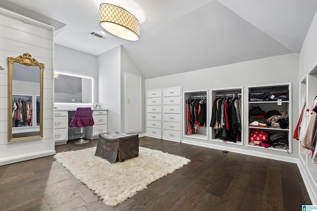 bedroom with dark hardwood / wood-style flooring, two closets, and vaulted ceiling