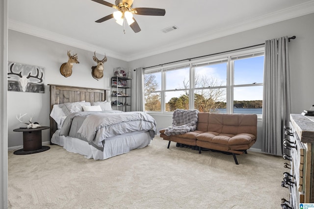 carpeted bedroom with ceiling fan, a water view, and crown molding