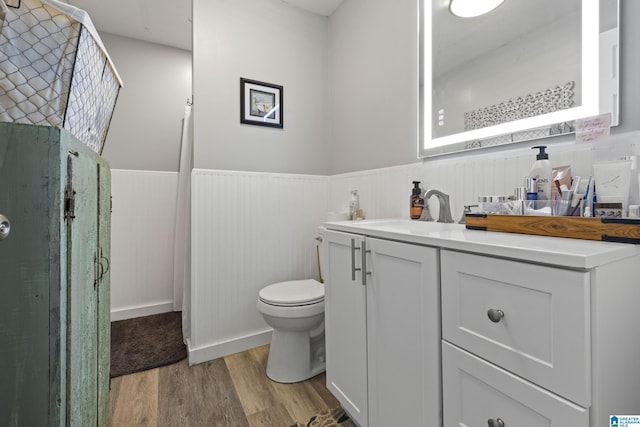 bathroom with vanity, wood-type flooring, and toilet