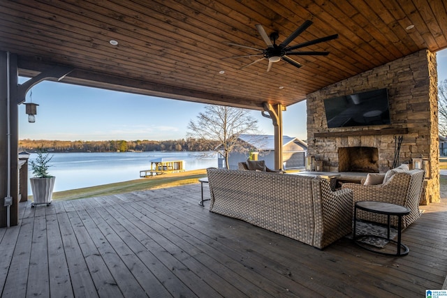 wooden deck featuring an outdoor living space with a fireplace and ceiling fan