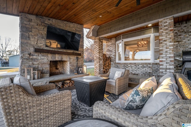 view of patio / terrace featuring an outdoor stone fireplace and ceiling fan