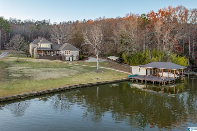 dock area featuring a lawn and a water view