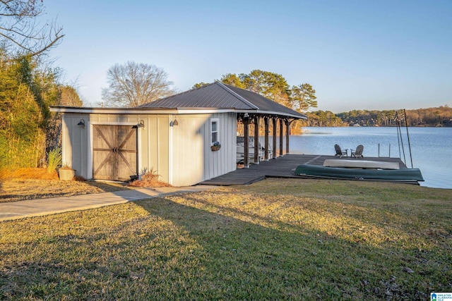 view of outbuilding featuring a yard and a water view