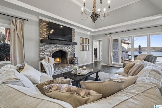 living room with high vaulted ceiling, crown molding, a fireplace, a notable chandelier, and wood-type flooring