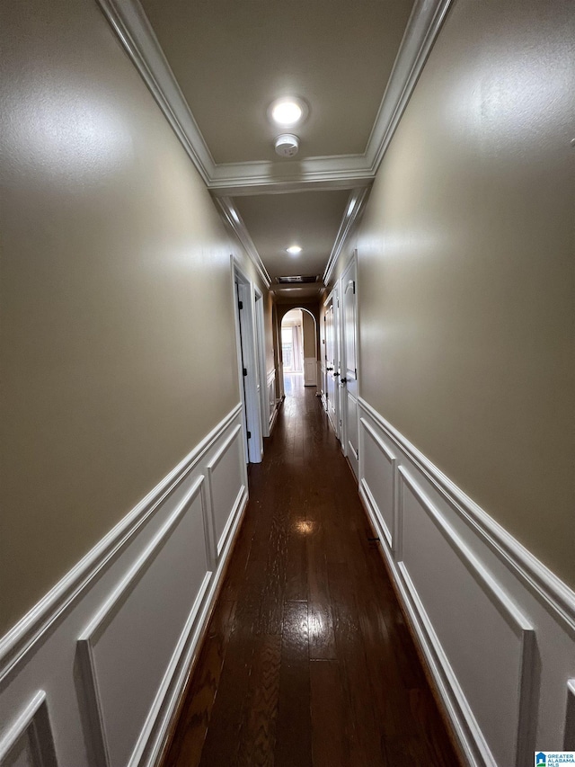 hall with dark hardwood / wood-style flooring and crown molding