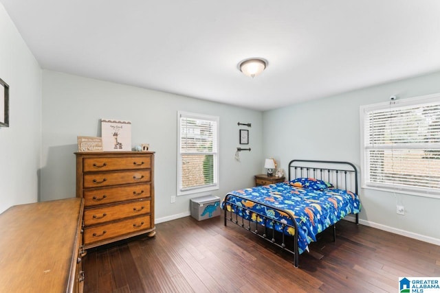 bedroom with dark hardwood / wood-style flooring