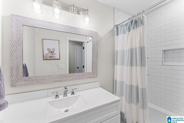 bathroom featuring vanity and shower / bathtub combination with curtain