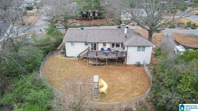 back of house with a deck and central air condition unit