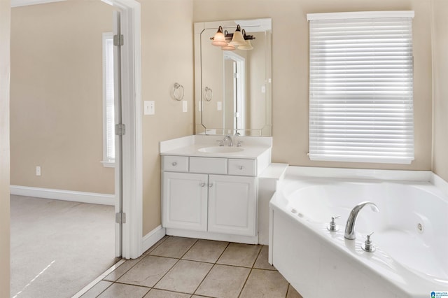 bathroom featuring tile patterned floors, a washtub, vanity, and a chandelier