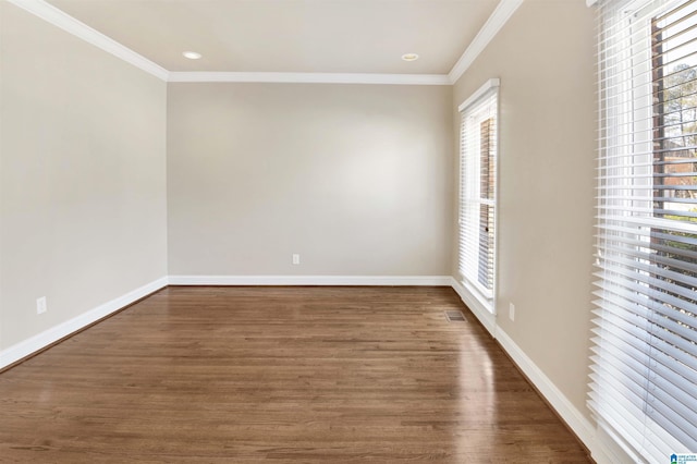 spare room featuring crown molding and dark wood-type flooring