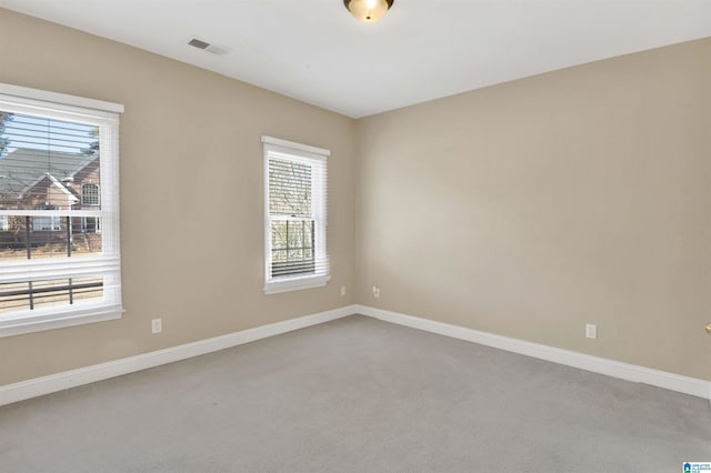 carpeted spare room featuring plenty of natural light