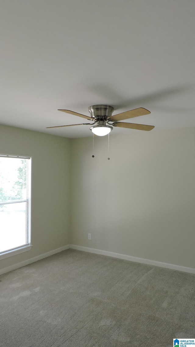 spare room featuring ceiling fan and carpet floors