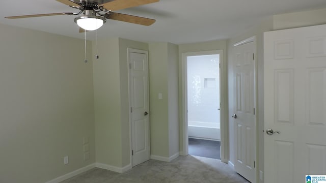 interior space featuring ceiling fan and light carpet