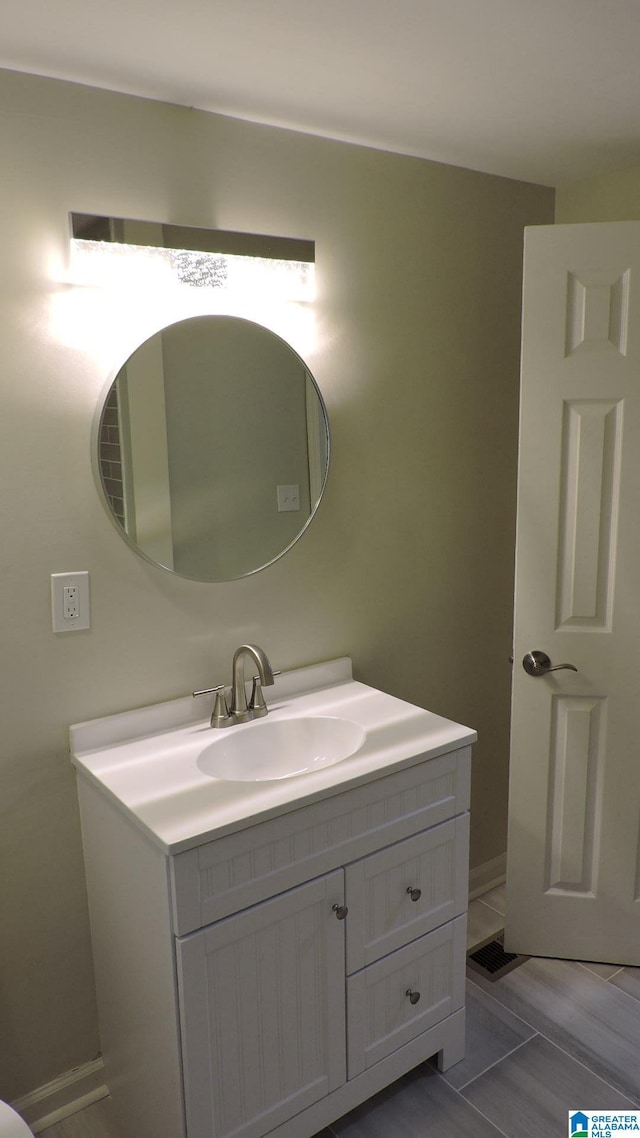 bathroom featuring hardwood / wood-style flooring and vanity