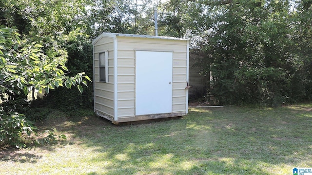 view of outbuilding with a lawn