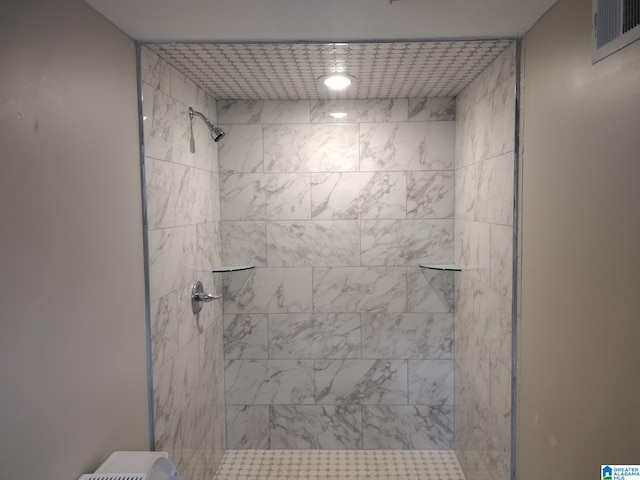 bathroom with tiled shower