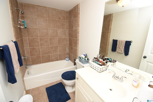 full bathroom with tile patterned floors, vanity, tiled shower / bath combo, and toilet