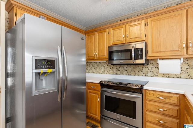 kitchen with decorative backsplash, appliances with stainless steel finishes, and a textured ceiling