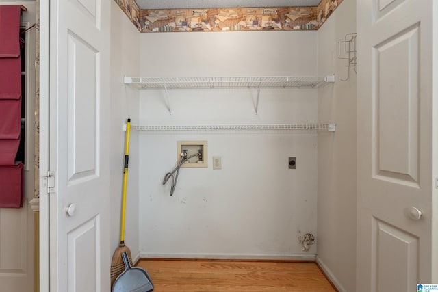 clothes washing area featuring hookup for a washing machine, hardwood / wood-style floors, a textured ceiling, and hookup for an electric dryer