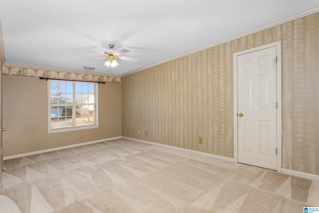 spare room with ceiling fan, carpet, and ornamental molding