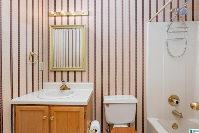 full bathroom featuring bathtub / shower combination, vanity, and toilet