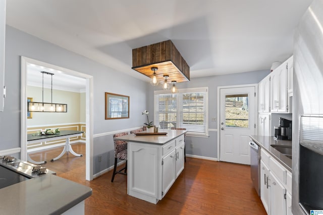 kitchen featuring a center island, white cabinets, hanging light fixtures, dark hardwood / wood-style floors, and appliances with stainless steel finishes