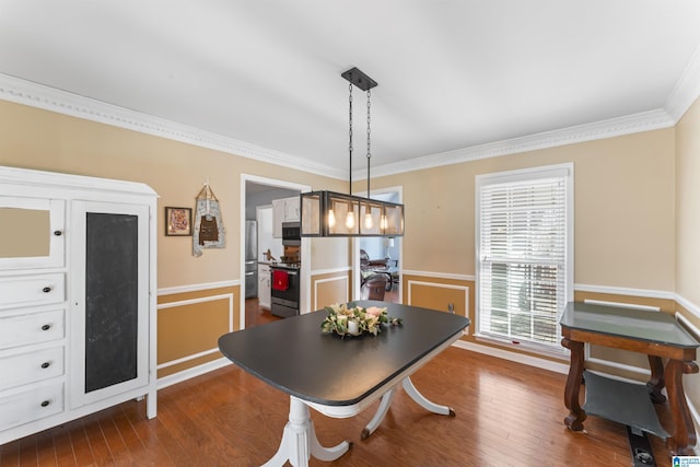 dining space featuring wood-type flooring and ornamental molding