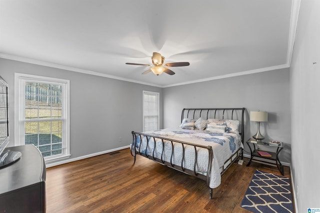 bedroom with dark hardwood / wood-style flooring, ceiling fan, and ornamental molding