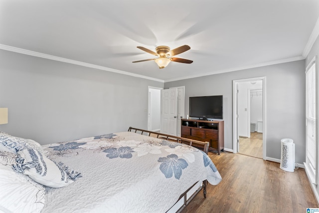 bedroom with ceiling fan, wood-type flooring, and crown molding