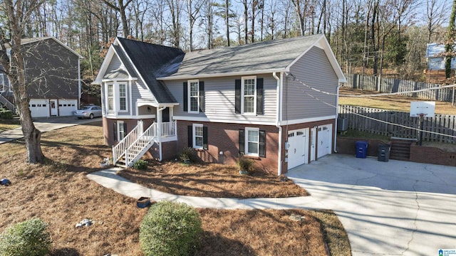 view of front of property featuring central AC and a garage