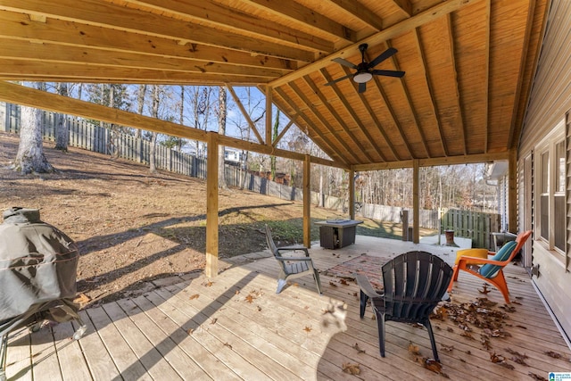 wooden deck with grilling area and ceiling fan