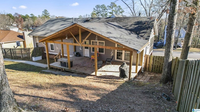 rear view of house featuring a wooden deck