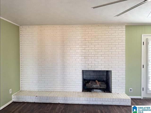 room details featuring hardwood / wood-style flooring, ornamental molding, a textured ceiling, and a brick fireplace