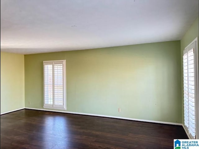 unfurnished room featuring dark wood-type flooring