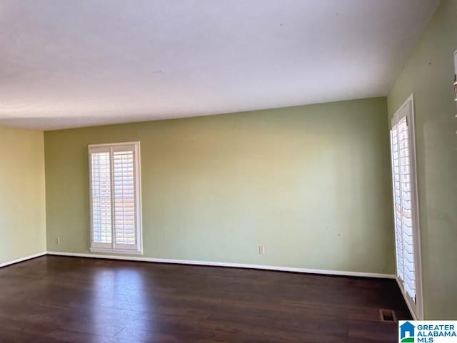 empty room with dark hardwood / wood-style floors