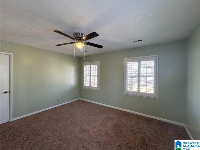 spare room with ceiling fan, carpet floors, and a textured ceiling