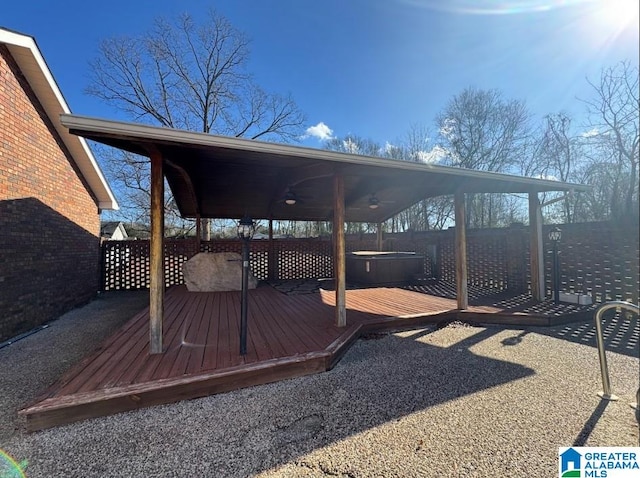 wooden deck featuring a hot tub